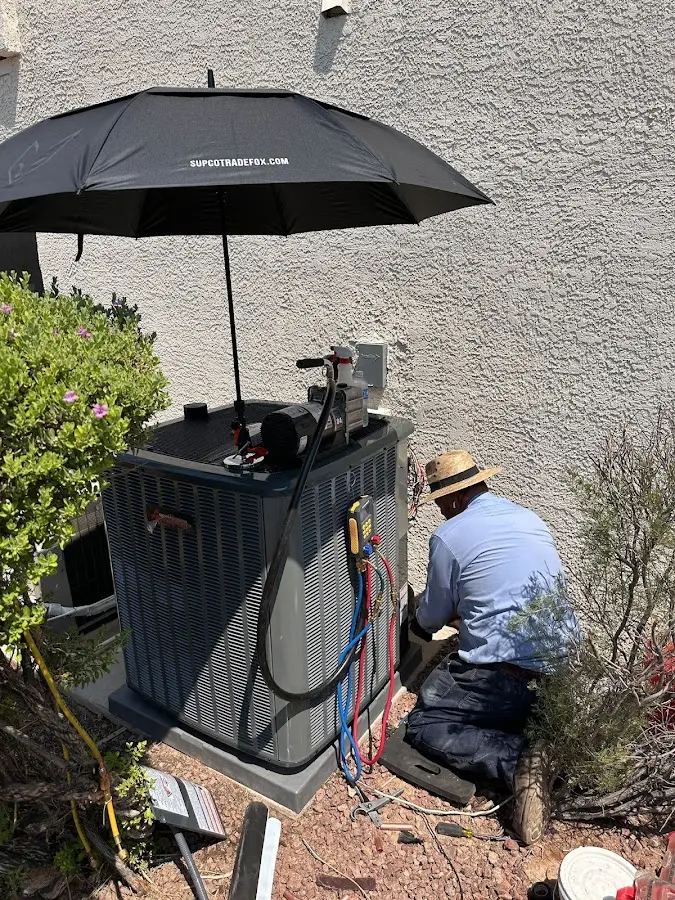 HVAC technician performing outdoor AC maintenance in Glendale Heights